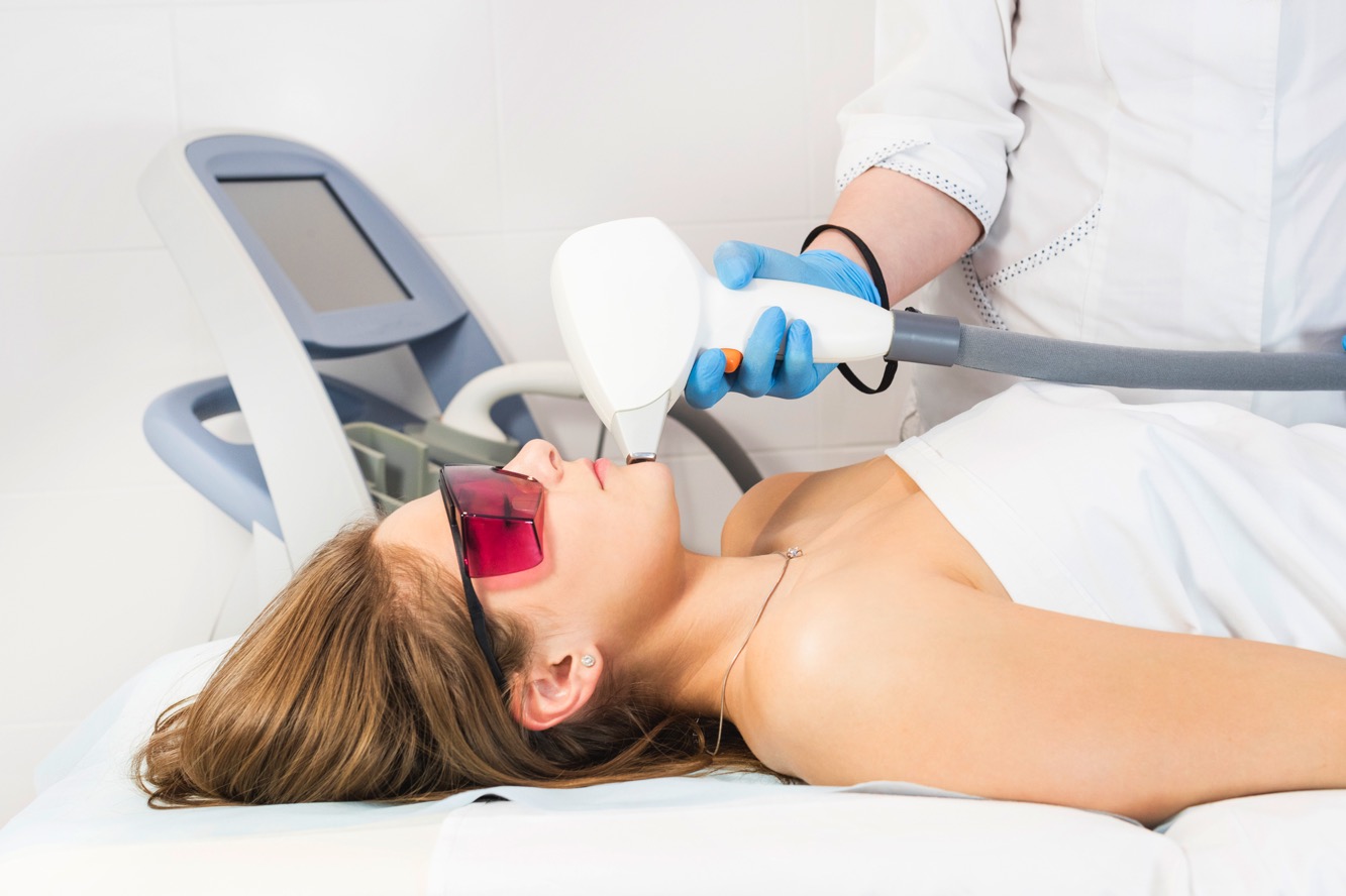 woman giving laser derm procedure